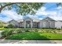 Inviting single-story home featuring a well-manicured lawn, lovely shrubs, and mature trees enhancing its curb appeal at 2161 Longleaf Cir, Lakeland, FL 33810