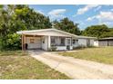 Single-story home with carport and screened-in porch at 129 5Th Jpv St, Winter Haven, FL 33880