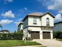 A charming two-story home boasting a two-car garage and meticulously kept green lawn and manicured hedges at 1056 Castle Pines Ct, Reunion, FL 34747