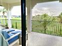 Relaxing patio with comfortable seating overlooking manicured lawns and lush trees at 1056 Castle Pines Ct, Reunion, FL 34747