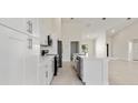 Bright kitchen with white cabinets, stainless steel appliances, and a large center island at 2021 Valencia Dr, Indian Lake Estates, FL 33855