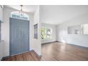 Bright entryway features wood flooring, white walls, and a transom window above the blue front door at 3055 Steeplechase Dr, Lakeland, FL 33811