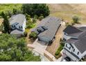 Aerial view of a home with an attached garage, lush landscaping, a screened in porch, and beautiful neighborhood at 547 Windsor Pl, Davenport, FL 33896
