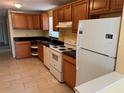 Functional kitchen featuring classic white appliances and dark countertops at 206 W 9Th St, Lakeland, FL 33805
