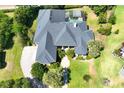 Aerial view of a luxury home with a pool, well-maintained landscaping, and a large driveway for multiple vehicles at 2660 Wyndsor Oaks Way, Winter Haven, FL 33884