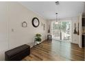 Cozy living space with wood floors, a large window for natural light, and a dining area at 6702 Brookridge Trl, Lakeland, FL 33810