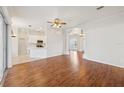 Spacious living room with hardwood floors, flowing into the open-concept kitchen and dining area at 1046 Island Pointe Dr, Winter Garden, FL 34787