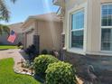 Detailed stone and stucco work highlight this well-landscaped corner of the home at 1415 Colonial Ct, Winter Haven, FL 33884