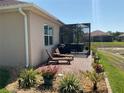 Outdoor patio featuring brick pavers, a screened-in area, hot tub, and relaxing seating at 1415 Colonial Ct, Winter Haven, FL 33884