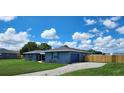 Stylish home featuring a well-maintained lawn, side garage and matching storage shed at 8804 Harrison Rd, Lakeland, FL 33810