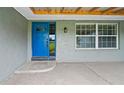Inviting covered entryway with a bright blue front door and large windows at 8804 Harrison Rd, Lakeland, FL 33810