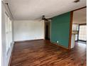 Spacious living room with hardwood floors, ceiling fan, and plenty of natural light at 11407 Bobwhite Blvd, Leesburg, FL 34788