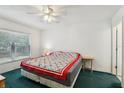 Cozy bedroom featuring a window for natural light and a ceiling fan for comfortable air circulation at 30653 Pga Dr, Sorrento, FL 32776