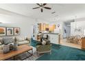 Cozy living room seamlessly flows into the kitchen and dining area, perfect for entertaining at 30653 Pga Dr, Sorrento, FL 32776