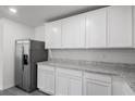 Bright kitchen featuring stainless steel refrigerator and granite countertops at 575 Bay Leaf Dr, Poinciana, FL 34759