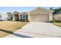 Charming single-story home with a two-car garage and well-maintained landscaping at 2138 Mirasol Dr, Winter Haven, FL 33881
