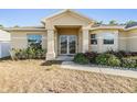 Inviting home exterior featuring a covered entrance and freshly landscaped garden beds at 2138 Mirasol Dr, Winter Haven, FL 33881