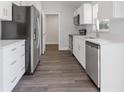 Modern kitchen boasts stainless steel appliances, sleek countertops, and stylish wood-look floors at 2686 Sw 144Th Ct, Ocala, FL 34481