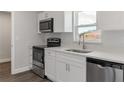 Modern kitchen showcasing stainless steel appliances and stylish white cabinetry at 2746 Sw 147Th Ct, Ocala, FL 34481