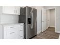 Close-up of a stainless steel refrigerator complementing the white cabinetry and countertops at 2746 Sw 147Th Ct, Ocala, FL 34481