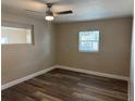 Comfortable bedroom with wood-look flooring, neutral paint, and bright natural light at 400 Sw 1St Ave, Mulberry, FL 33860