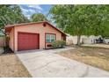 Cozy single-story home featuring a concrete driveway and landscaped shrubbery at 1313 Periwinkle Ct, Lakeland, FL 33811