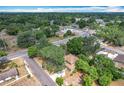 Aerial shot of a charming home nestled amongst mature trees in a quiet neighborhood at 713 W 3Rd St, Lakeland, FL 33805