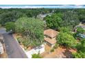 Property aerial view of house surrounded by a lush canopy of mature trees at 713 W 3Rd St, Lakeland, FL 33805