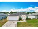 Well-maintained single-story home featuring a two-car garage and a landscaped front yard at 1639 Saddlehorn Dr, Lakeland, FL 33810