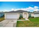 Charming single-story home with a well-manicured lawn and a two-car garage at 1639 Saddlehorn Dr, Lakeland, FL 33810