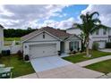 Attractive single-story home with a two-car garage, well-maintained lawn, and appealing curb appeal in a quiet neighborhood at 3205 Royal Tern Dr, Winter Haven, FL 33881