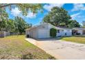 One-story home features an attached garage and a driveway at 3360 Cross Fox Dr, Mulberry, FL 33860