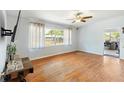 Bright living room with wood floors, a large window and neutral-colored walls at 1895 Emerson Ave, Bartow, FL 33830