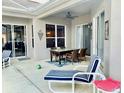 Relaxing covered patio with dining area and comfortable seating at 242 Prestwick Dr, Davenport, FL 33897
