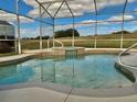 Inviting screened-in pool and spa offer an exceptional outdoor experience at 242 Prestwick Dr, Davenport, FL 33897