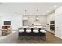 Modern kitchen with stainless steel appliances, a large island with seating, and sleek countertops at 5914 Bristle Oak St, Mount Dora, FL 32757