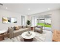 Bright living room features stylish furniture, neutral decor, and sliding glass doors to the backyard at 5914 Bristle Oak St, Mount Dora, FL 32757