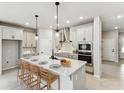 Modern kitchen featuring a large island with seating and stainless steel appliances at 6051 Sacred Oak Ave, Mount Dora, FL 32757
