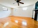 Spacious living room features wood floors, light colored walls, and natural light from multiple windows at 1690 S Mcadoo Ave, Bartow, FL 33830