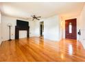 Bright living room with hardwood floors, a decorative fireplace, and a stylish front door at 1690 S Mcadoo Ave, Bartow, FL 33830