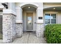 Close up of the front door with stone columns and a house number on the house at 7682 Fairfax Dr, Kissimmee, FL 34747