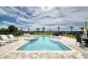 A beautiful pool features lounge chairs and an integrated hot tub, perfect for relaxation and enjoyment at 7682 Fairfax Dr, Kissimmee, FL 34747