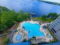 Aerial view of a resort style pool overlooking a lake at 13415 Blue Heron Beach Dr # 1006, Orlando, FL 32821