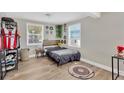Bright bedroom with light gray walls, wood-look floors, and two windows for natural light at 211 Nw 8Th St, Mulberry, FL 33860