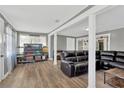 Spacious living room features modern floors, neutral walls, and a comfortable leather sofa set at 211 Nw 8Th St, Mulberry, FL 33860