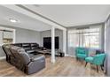 Open-concept living area features modern flooring, comfortable seating, and ample natural light at 211 Nw 8Th St, Mulberry, FL 33860