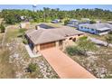 Aerial view of the home with a private driveway, mature trees, and well-maintained lawn at 6531 Red Grange Blvd, Indian Lake Estates, FL 33855