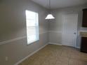 Cozy dining area with a window, overhead light fixture, and tile flooring at 6954 Glenbrook Dr, Lakeland, FL 33811