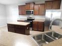 Open kitchen featuring stainless steel appliances, tile backsplash, and an island at 6954 Glenbrook Dr, Lakeland, FL 33811