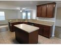 Open kitchen with wooden cabinets, center island and view to Gathering room at 6954 Glenbrook Dr, Lakeland, FL 33811